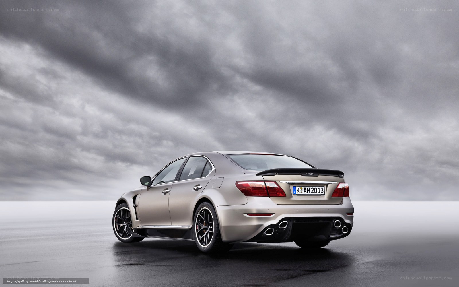 silver luxury sedan on wet road