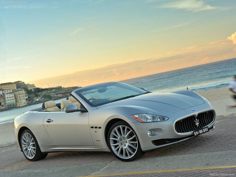 Silver Maserati convertible on beach