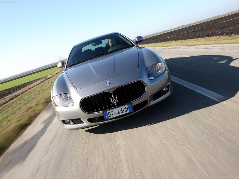 silver maserati driving on country road