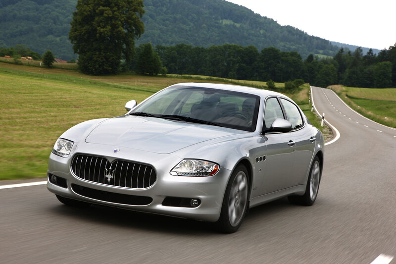 silver maserati driving on country road