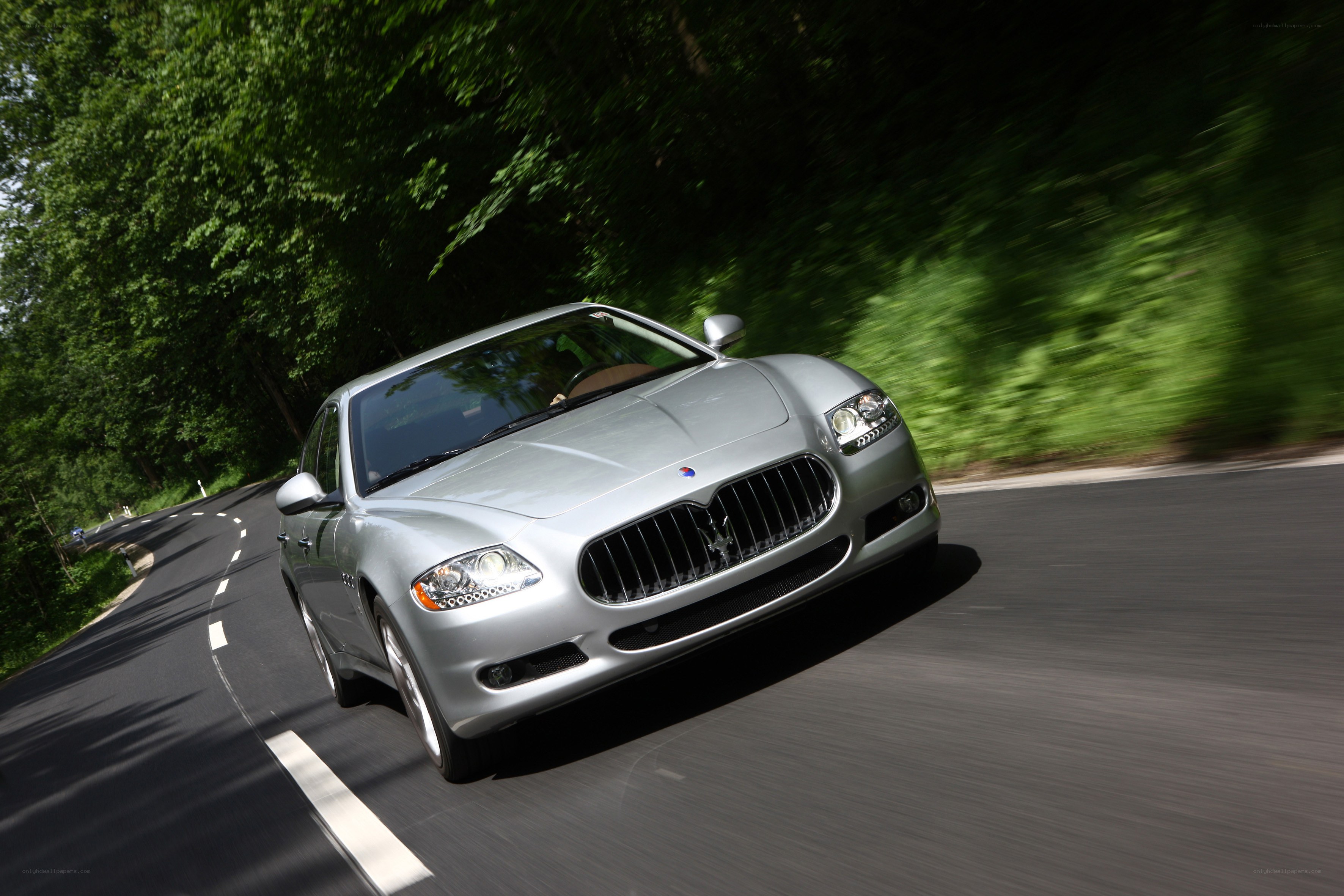 silver maserati driving on road