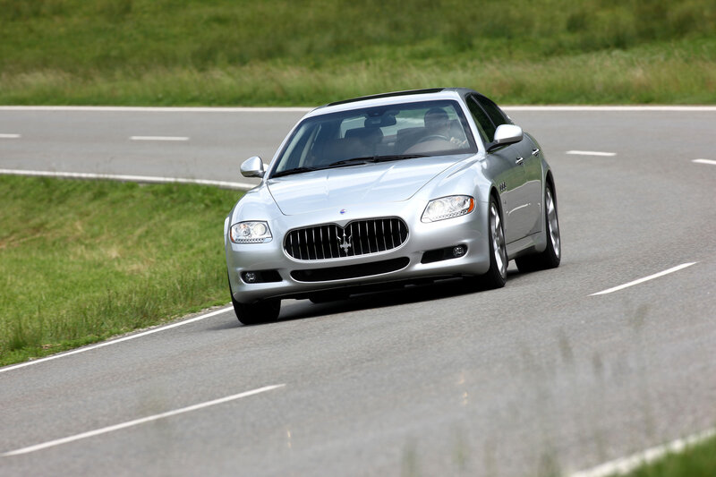 silver maserati driving on road