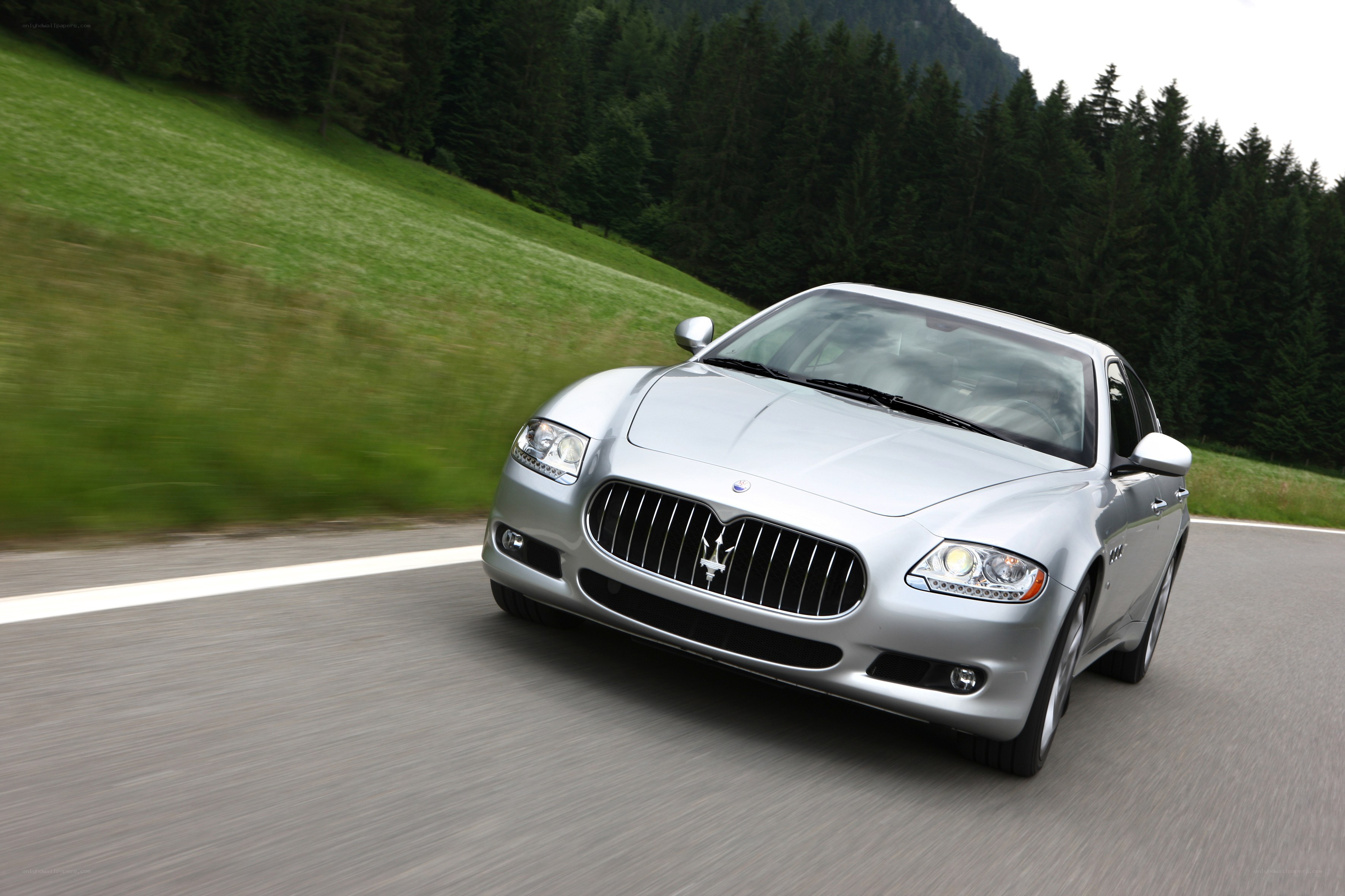 silver maserati driving on road