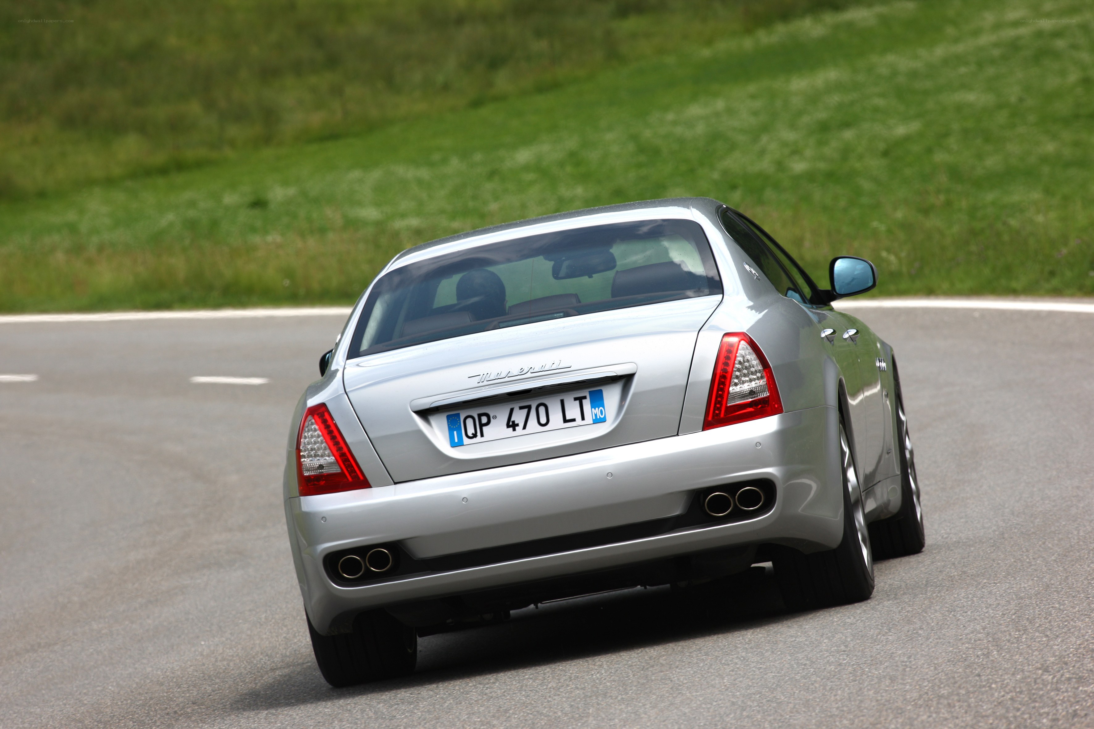 silver maserati driving on road