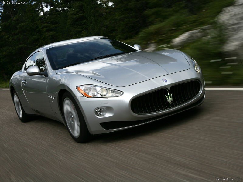 silver maserati driving on road