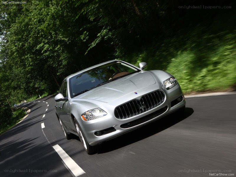 silver maserati driving on road