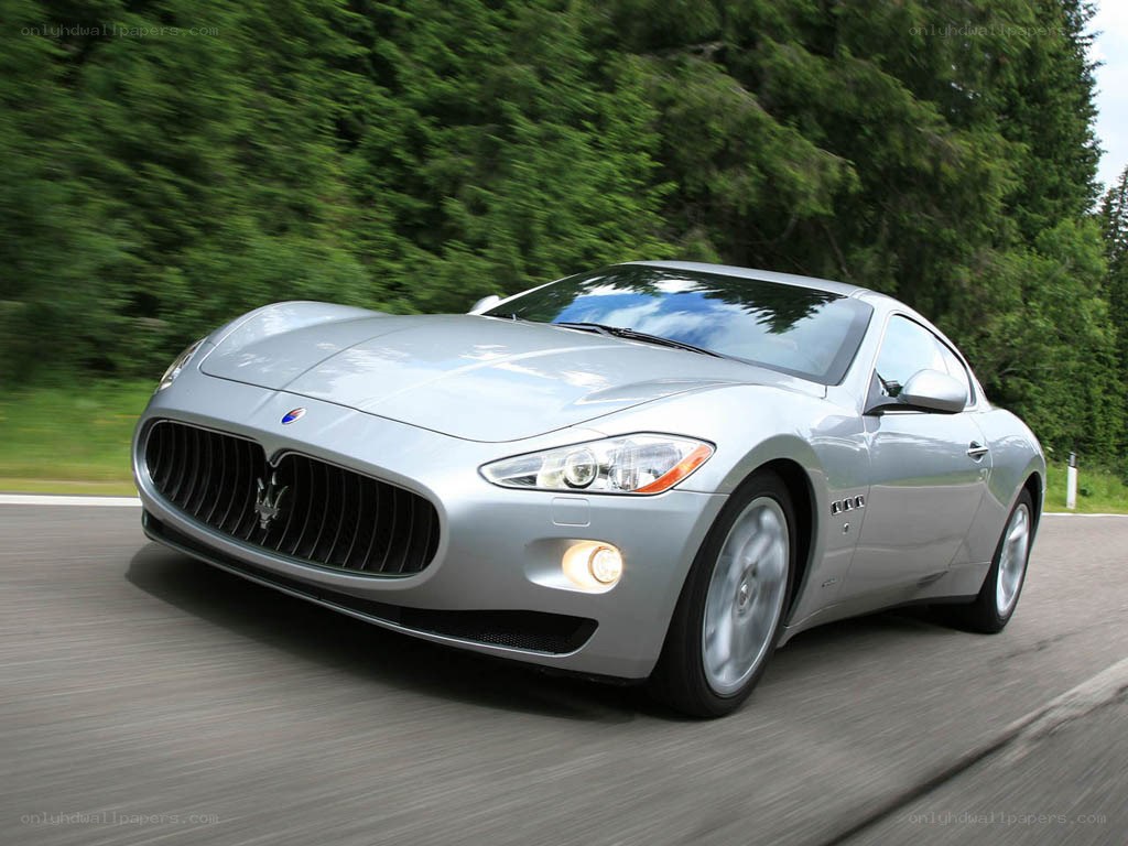 silver maserati driving on road