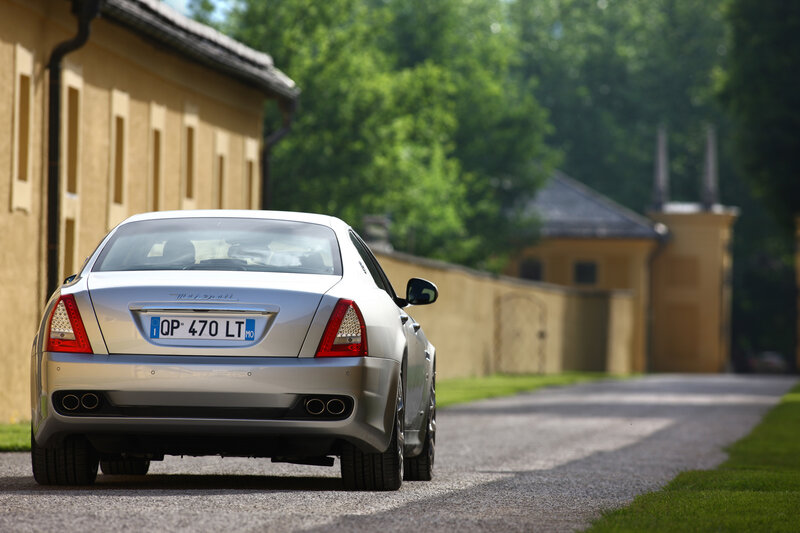 Silver Maserati on a country road