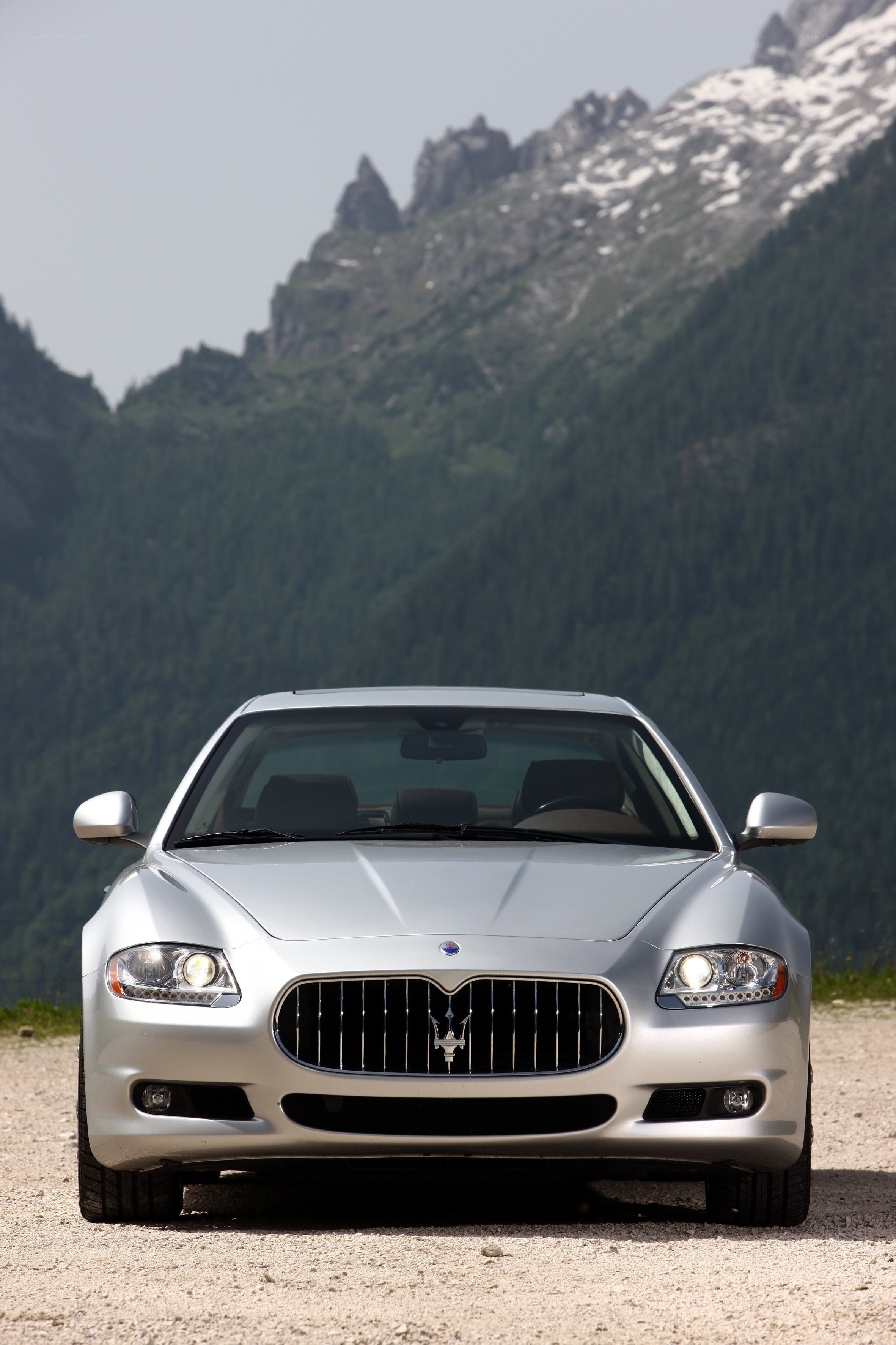 Silver Maserati on mountain road