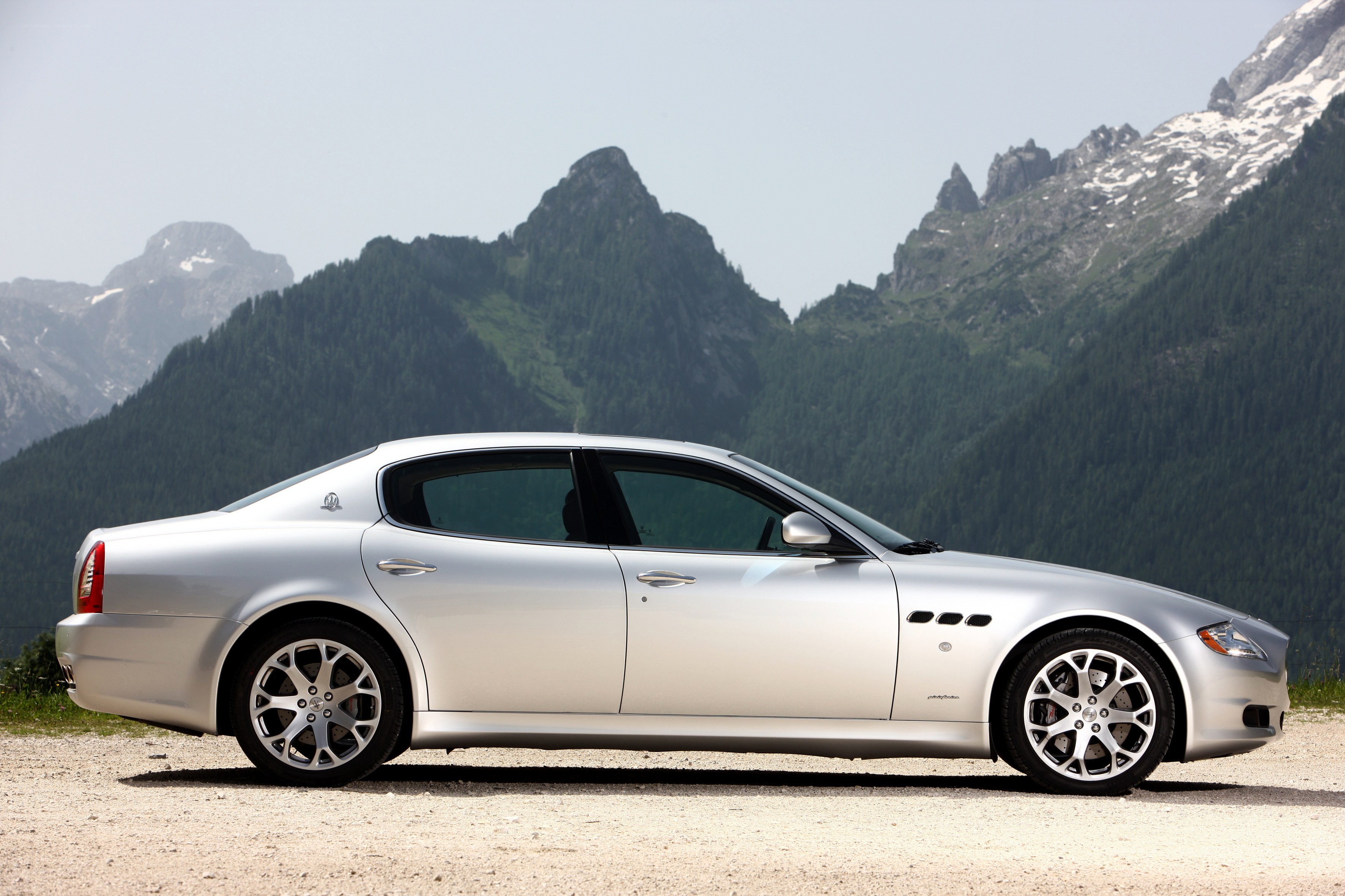 Silver Maserati on mountain road