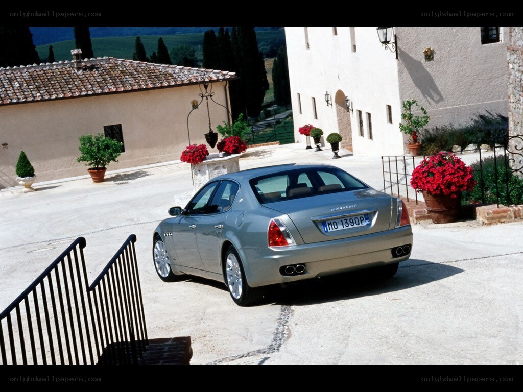 Silver Maserati parked in courtyard