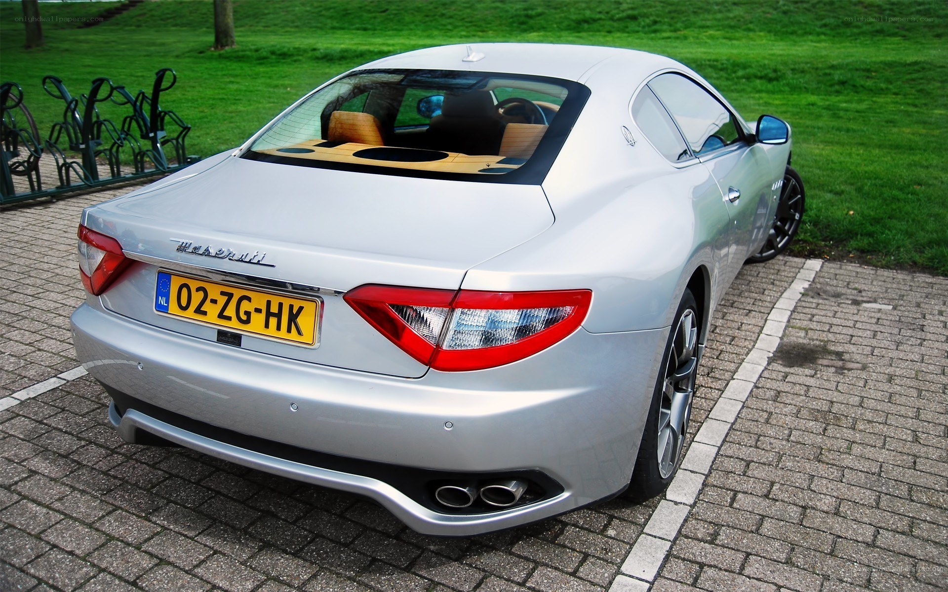 silver maserati parked on pavement