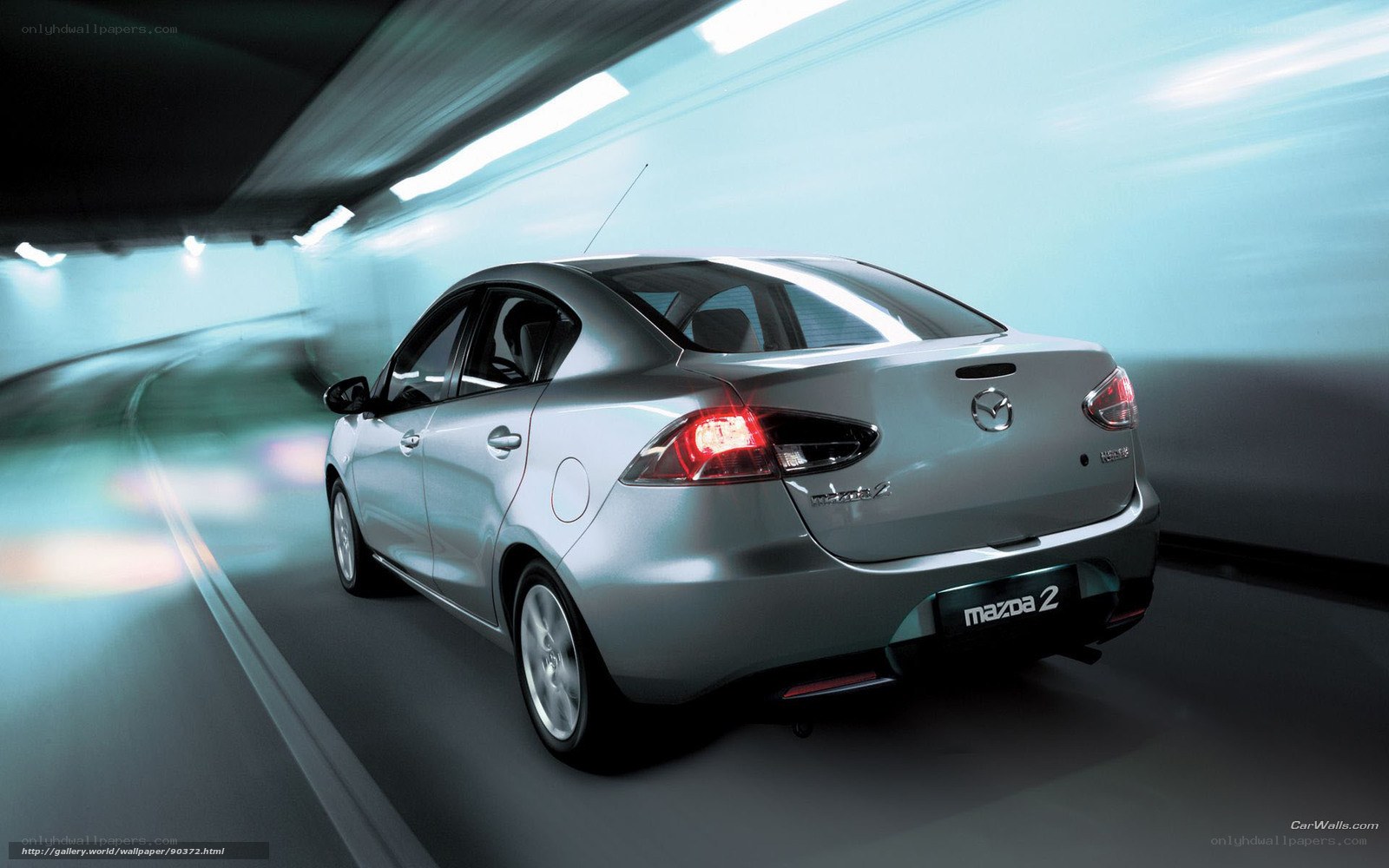 Silver Mazda 2 in tunnel