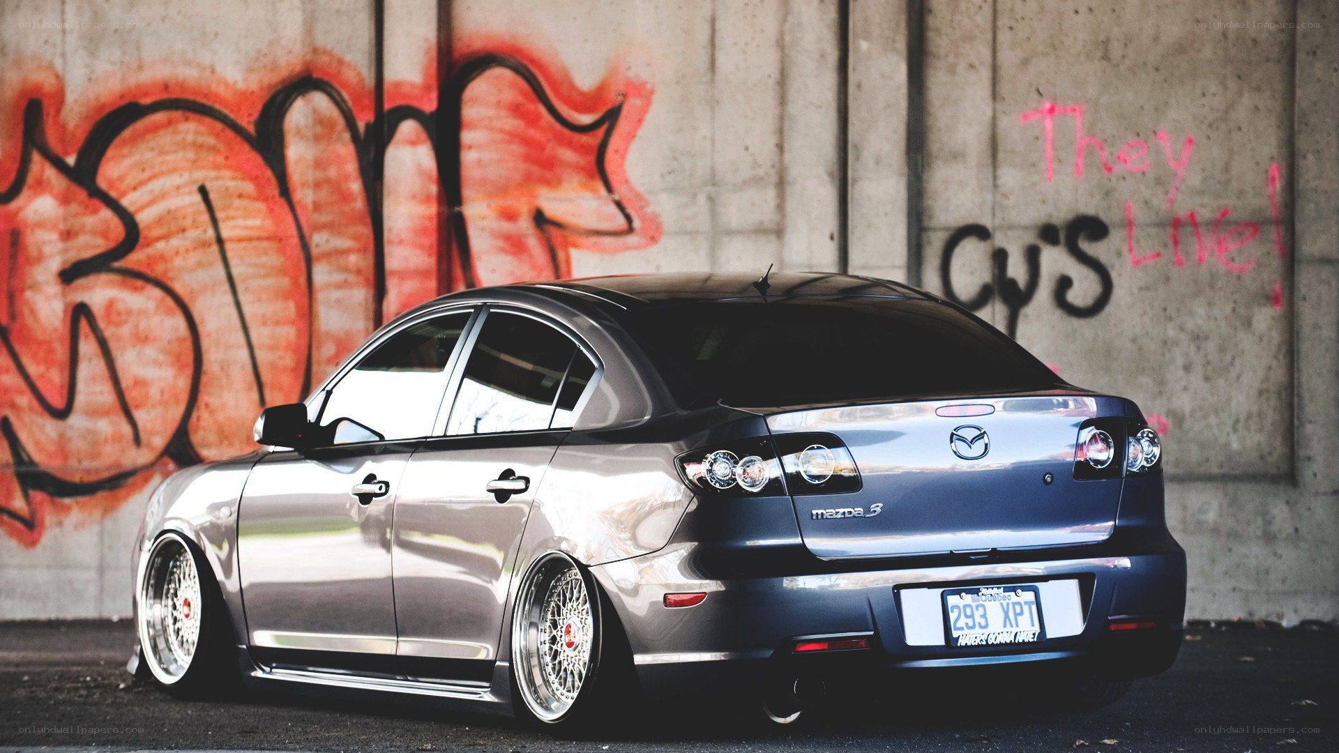 silver mazda 3 with custom wheels