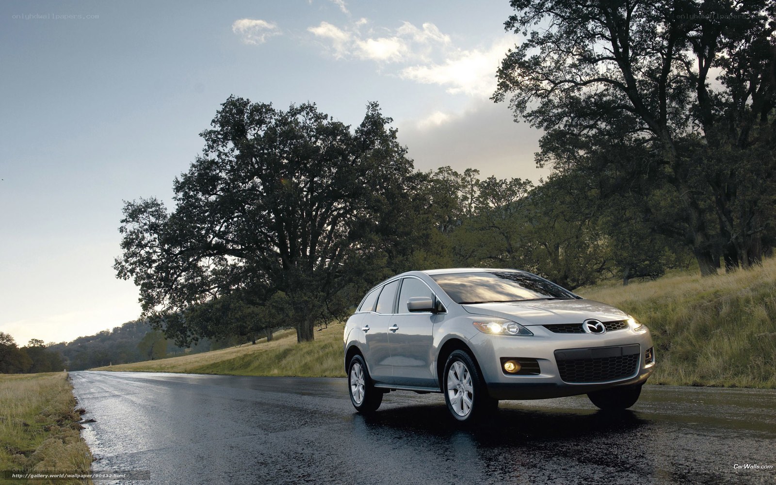 Silver Mazda CX-7 on a wet road