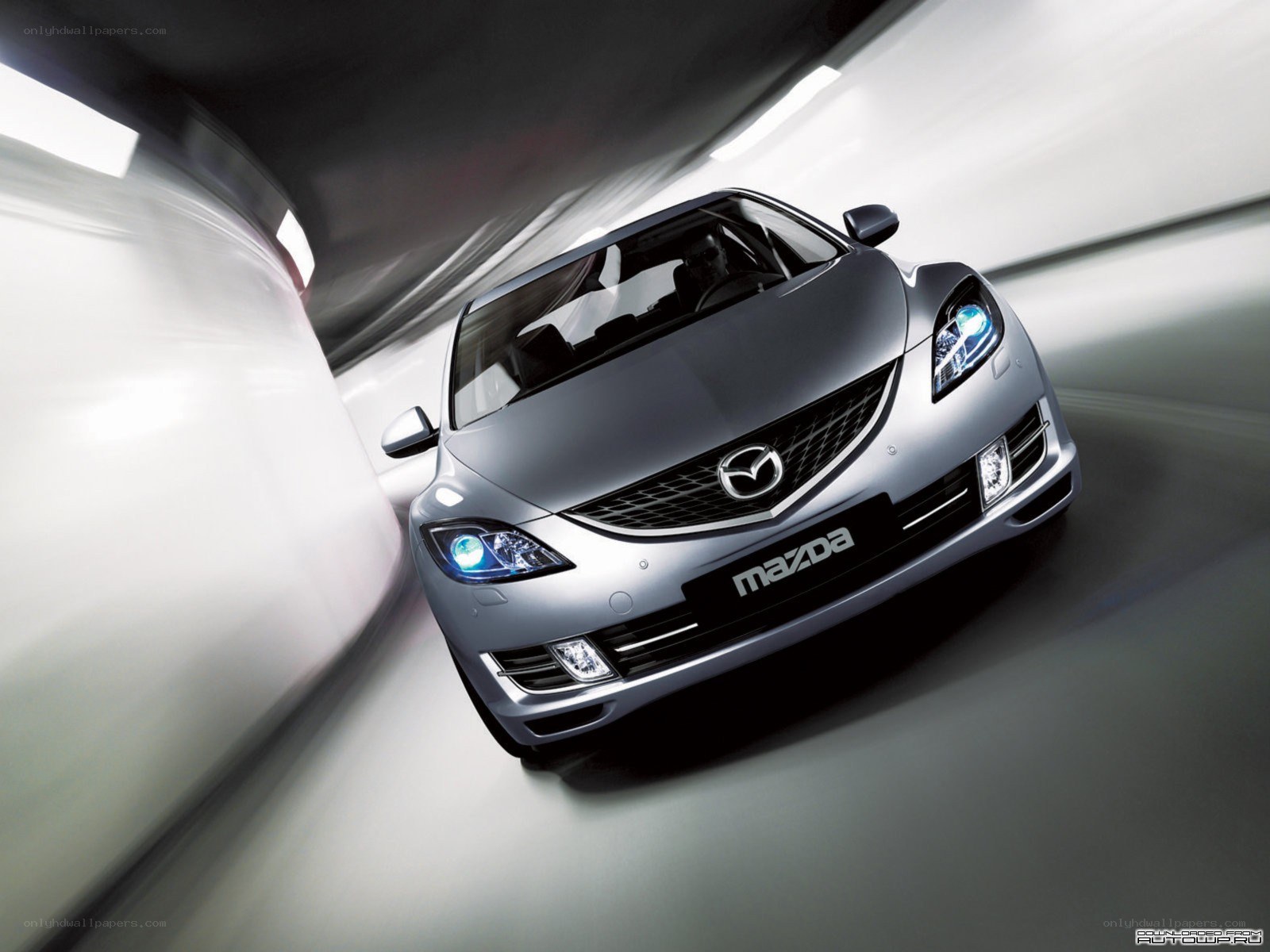 Silver Mazda in a tunnel