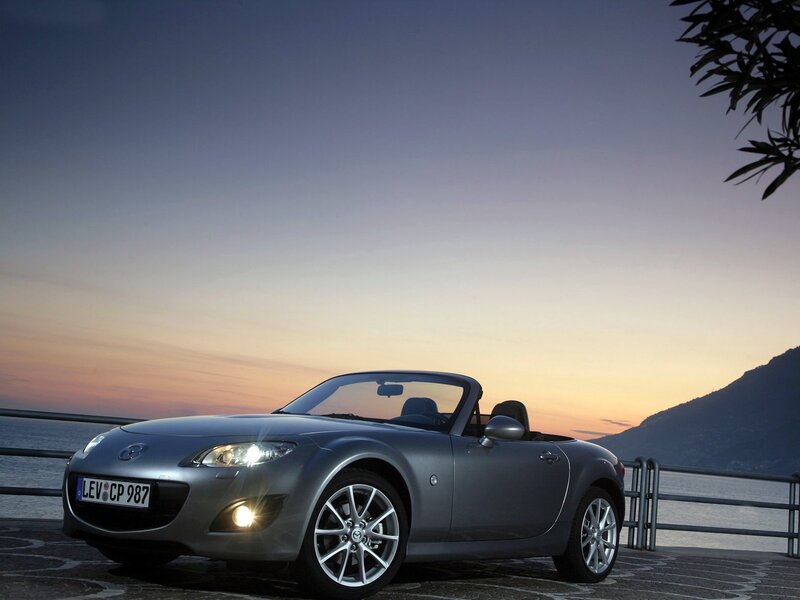 Silver Mazda Miata at sunset