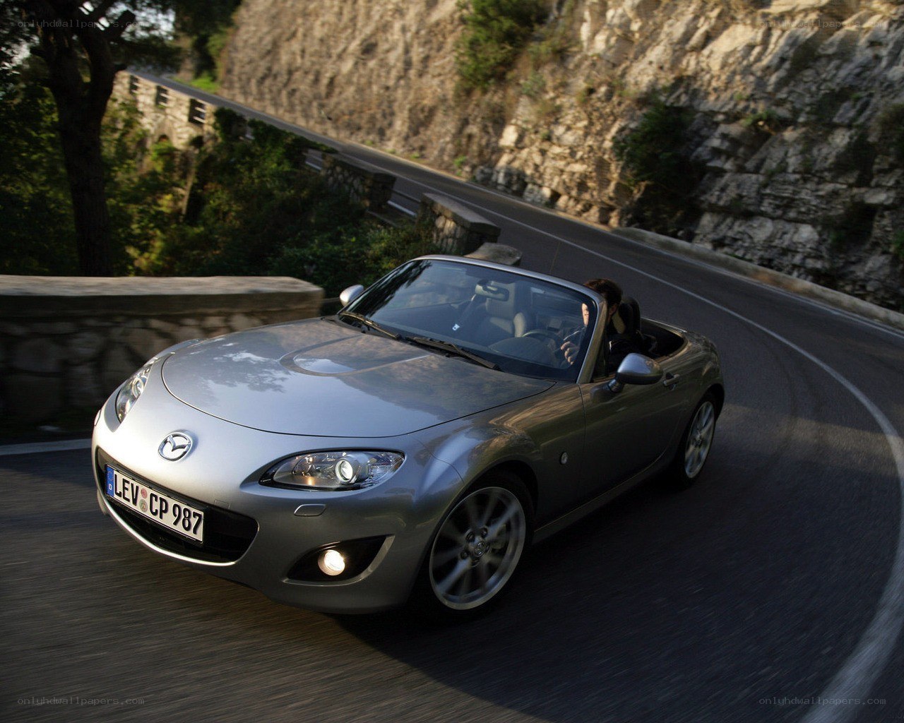 Silver Mazda Miata on winding road