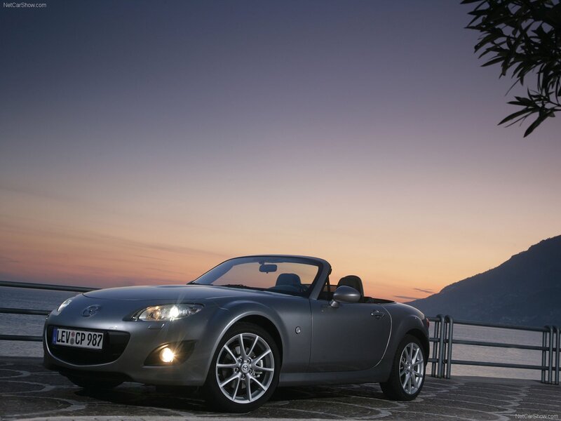 Silver Mazda MX-5 at sunset