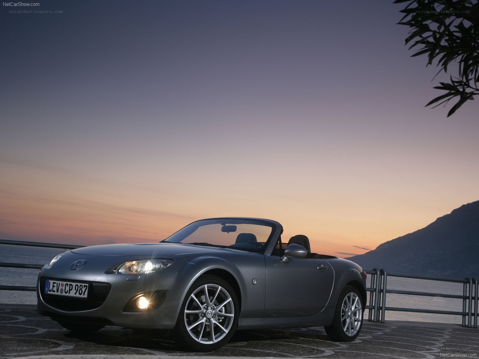 Silver Mazda MX-5 at sunset