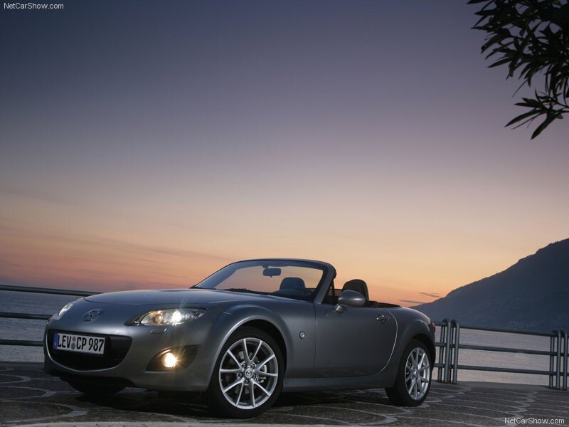 Silver Mazda MX-5 at sunset