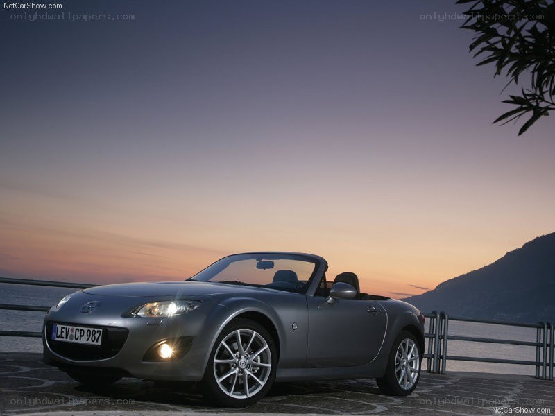 Silver Mazda MX-5 at sunset