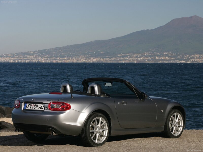 Silver Mazda MX-5 by the sea