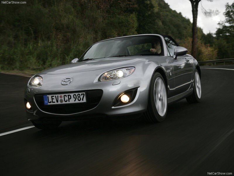 silver mazda mx-5 driving on road