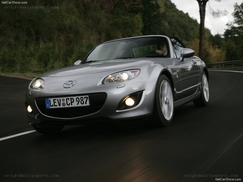 silver mazda mx-5 driving on road