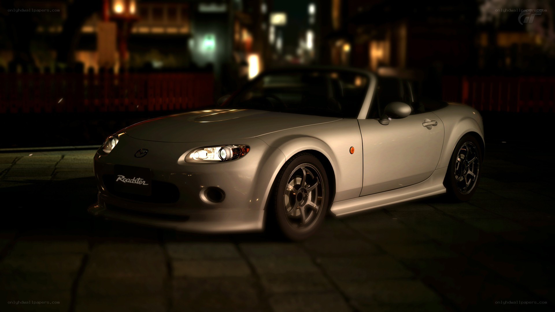 silver mazda roadster at night