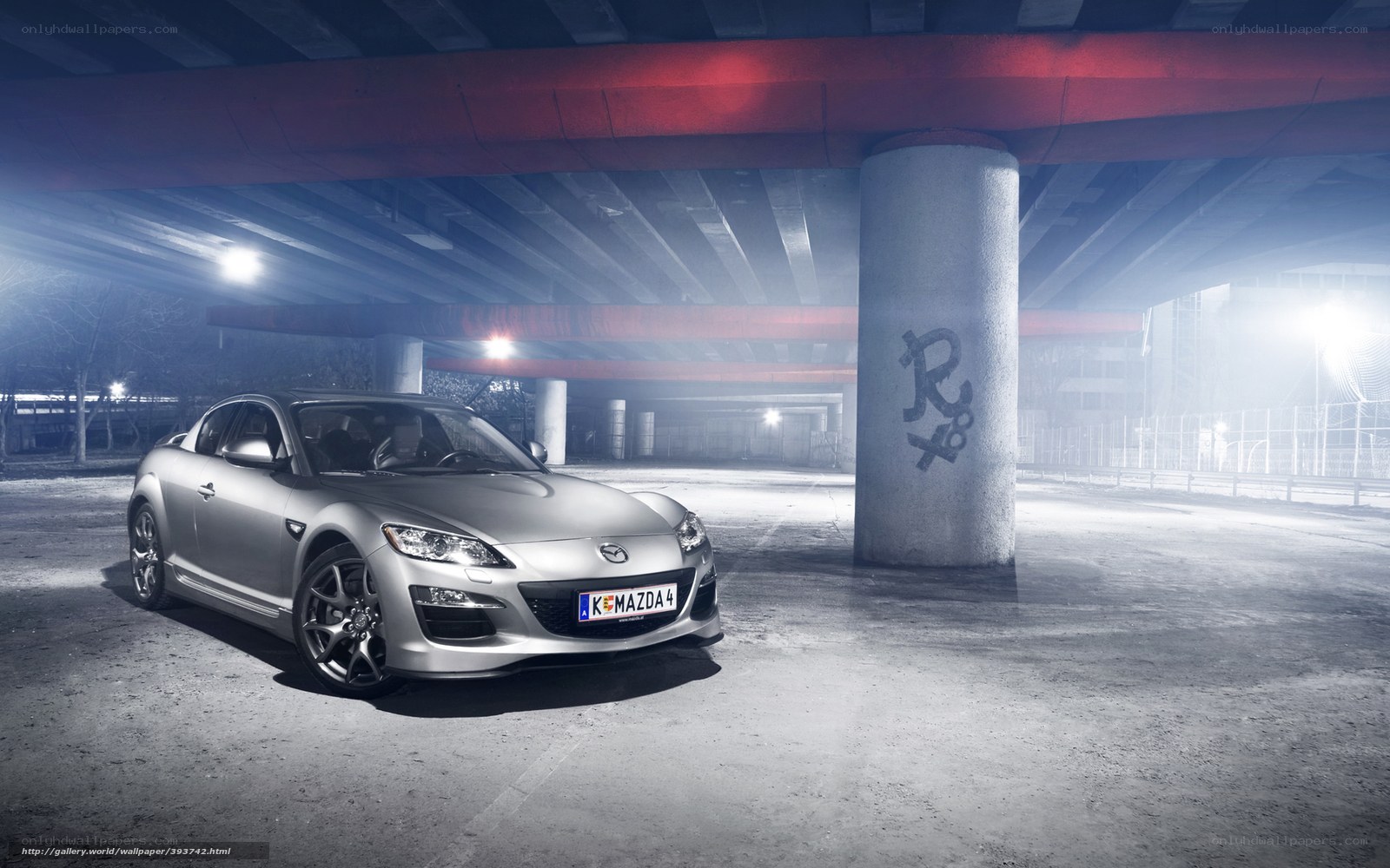 Silver Mazda RX-8 under bridge
