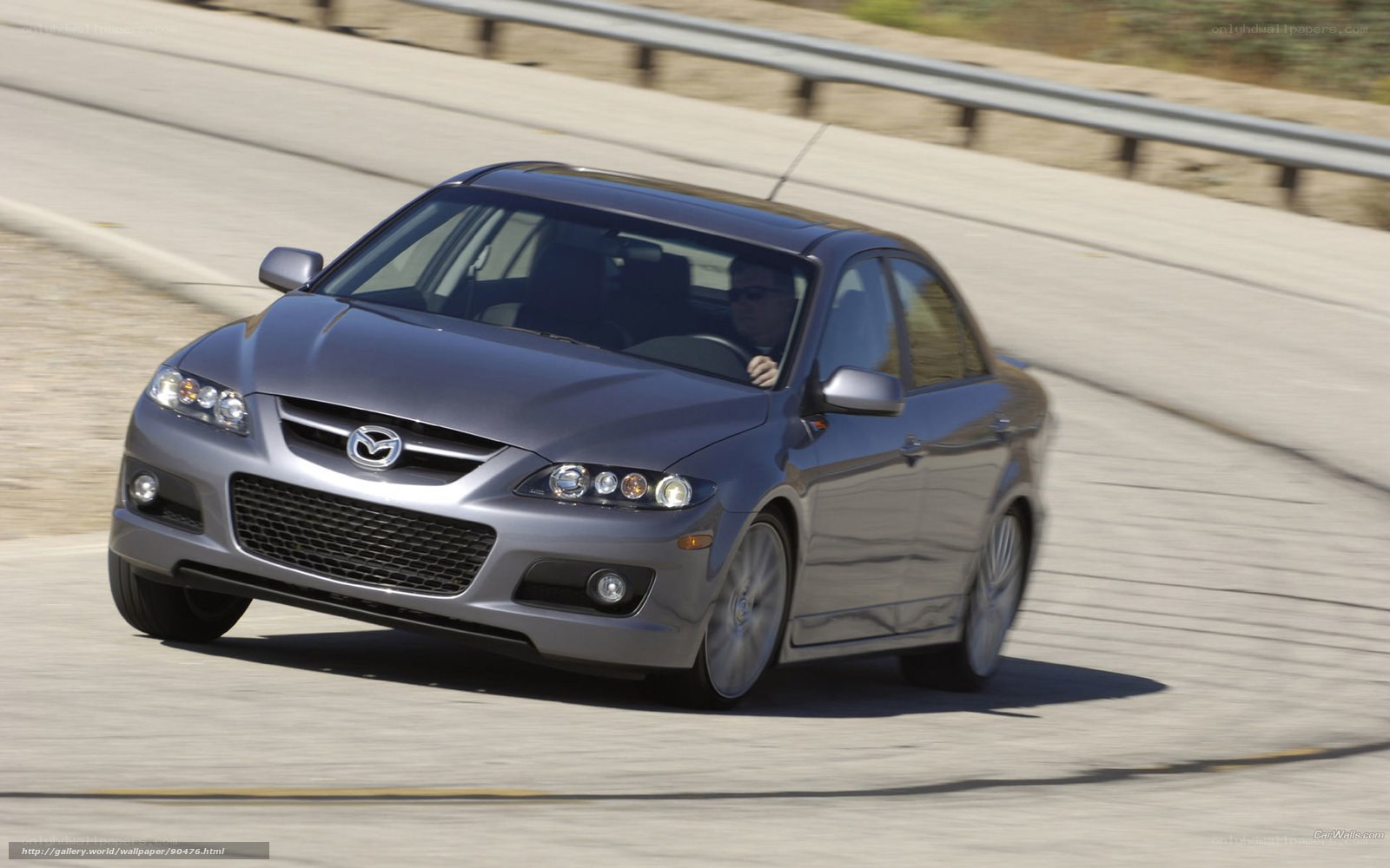 silver mazda sedan driving