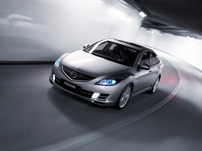 Silver Mazda sedan in motion