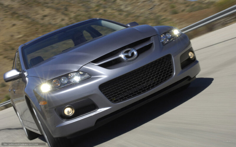silver mazda speeding on road