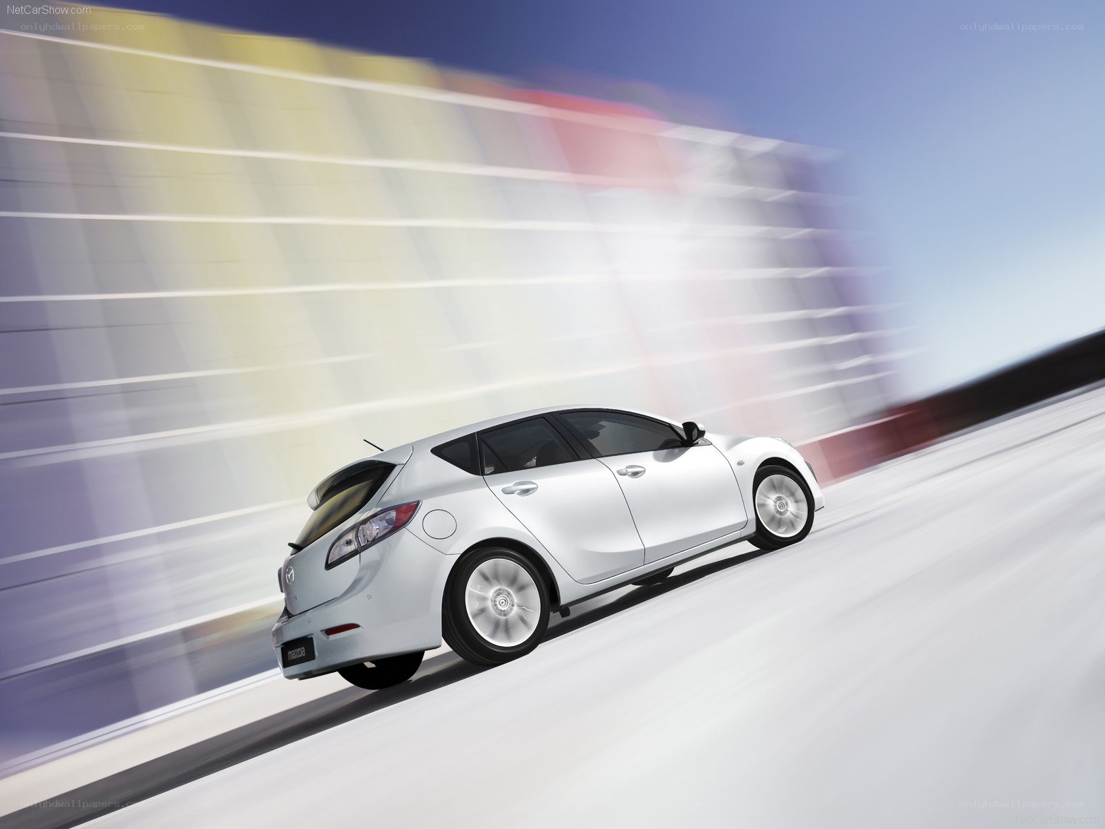 silver mazda3 hatchback in motion