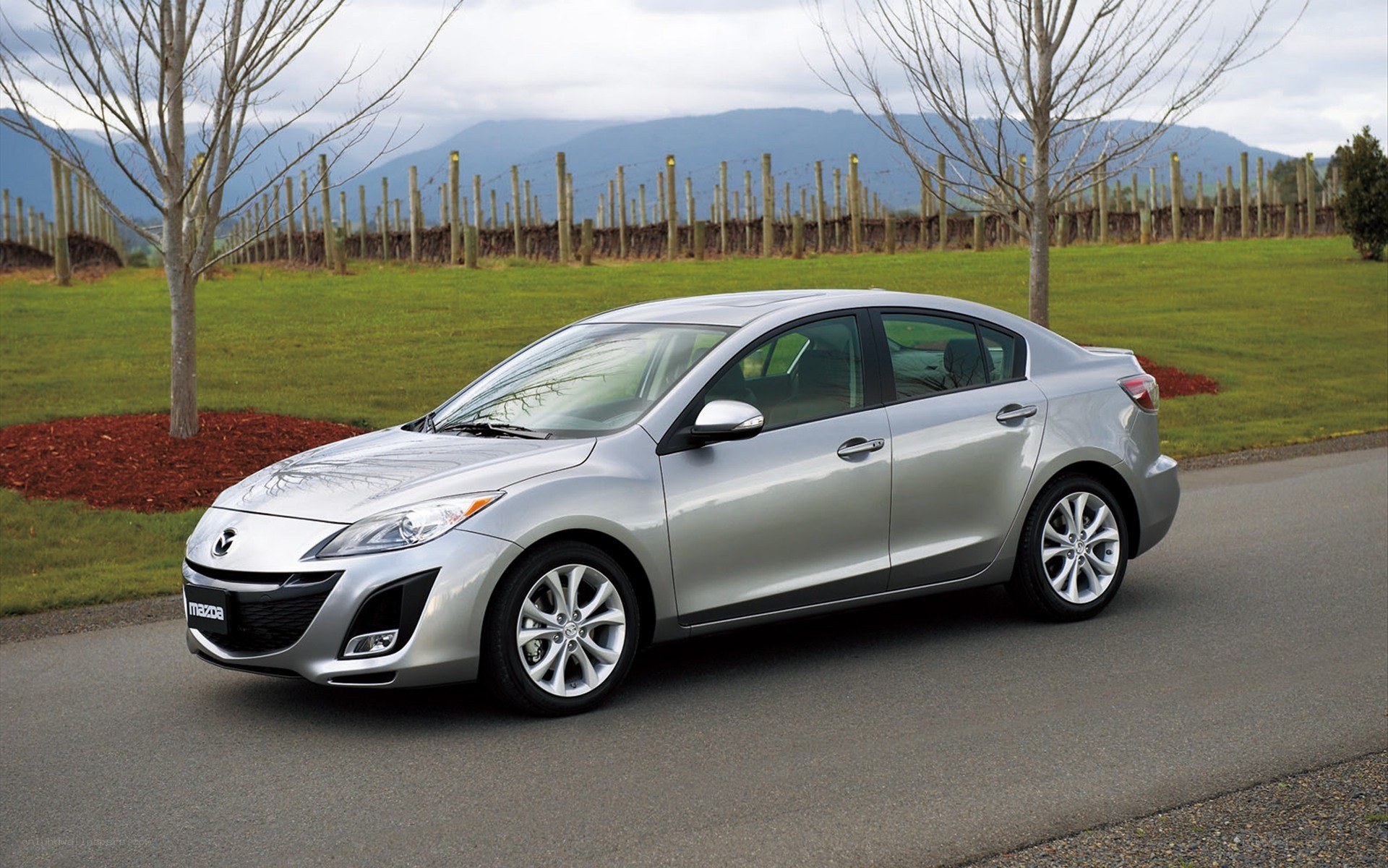 Silver Mazda3 sedan on a road