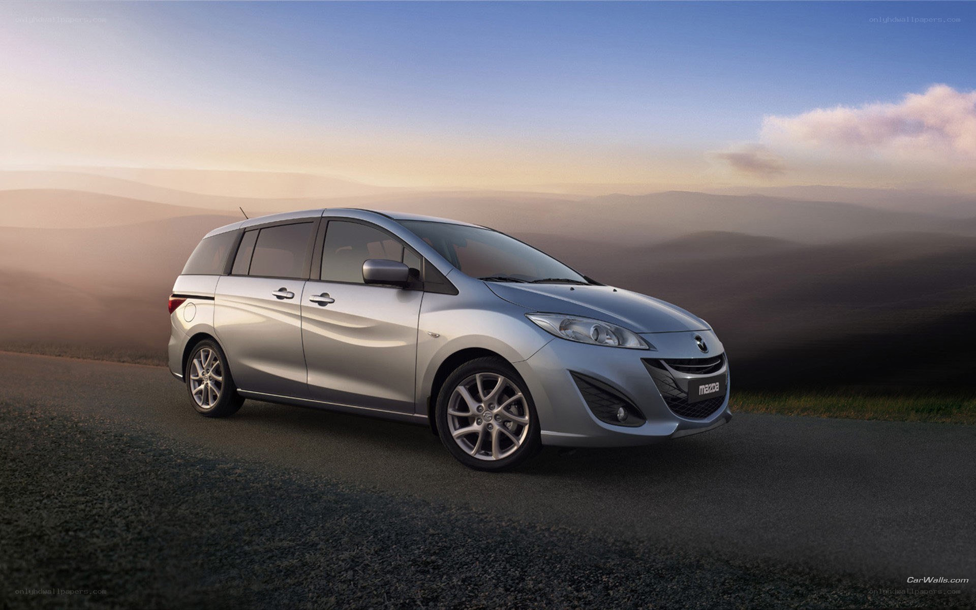 Silver Mazda5 on a scenic road