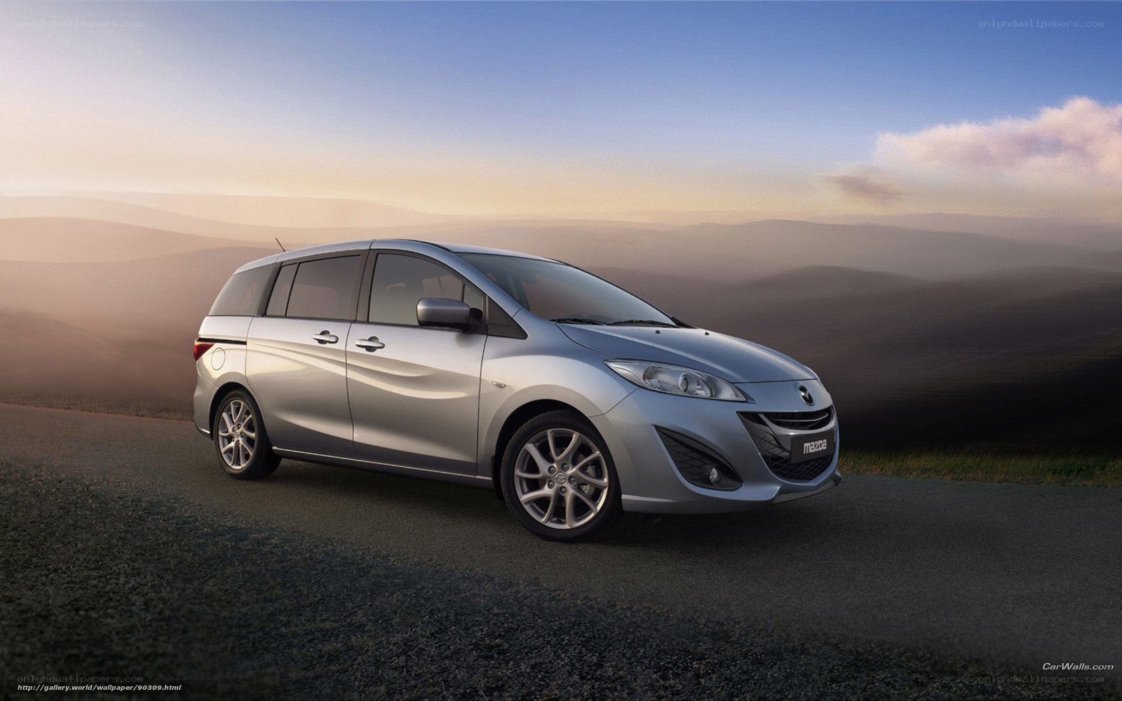 Silver Mazda5 on a scenic road