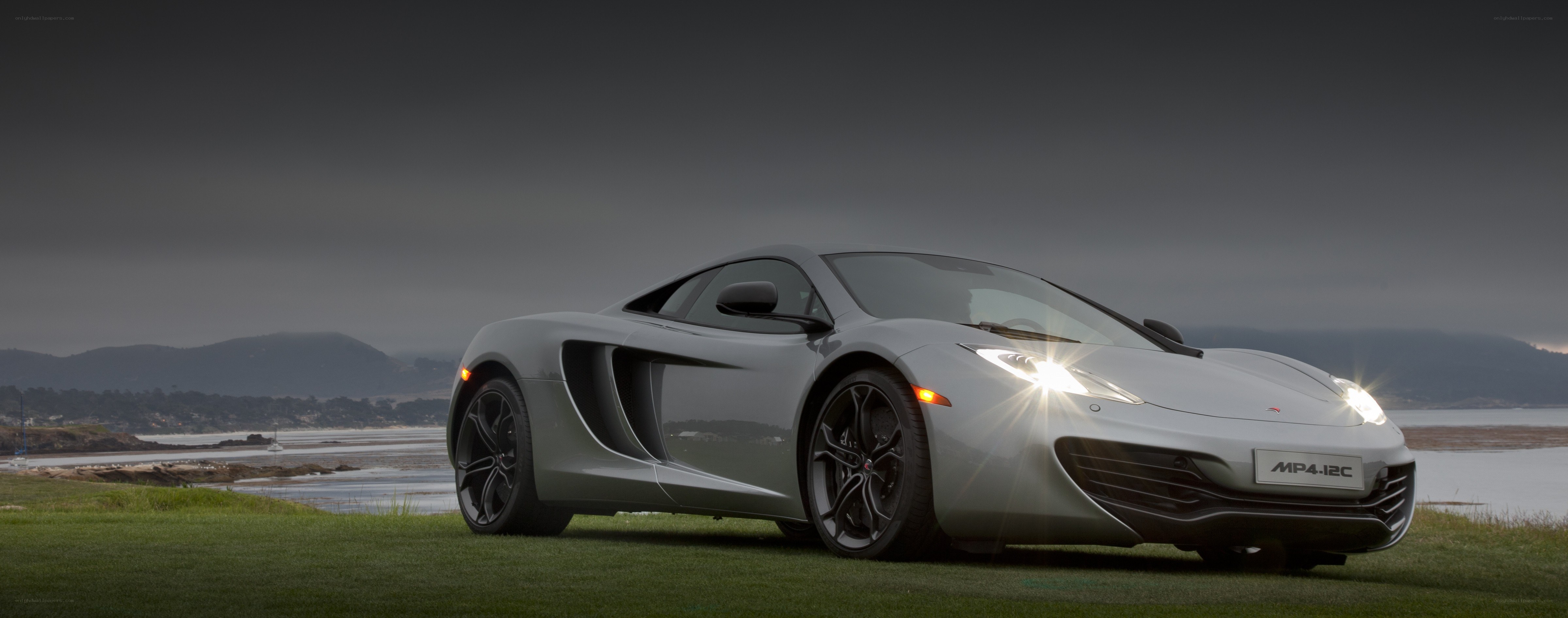 Silver McLaren MP4-12C on grass