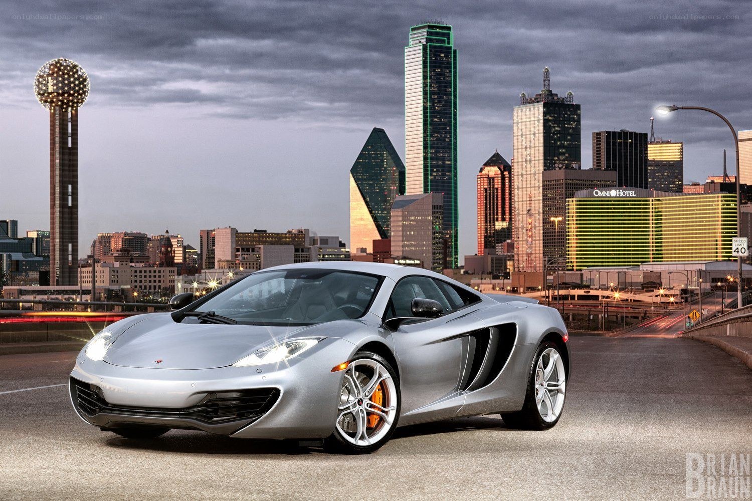 Silver McLaren on city bridge