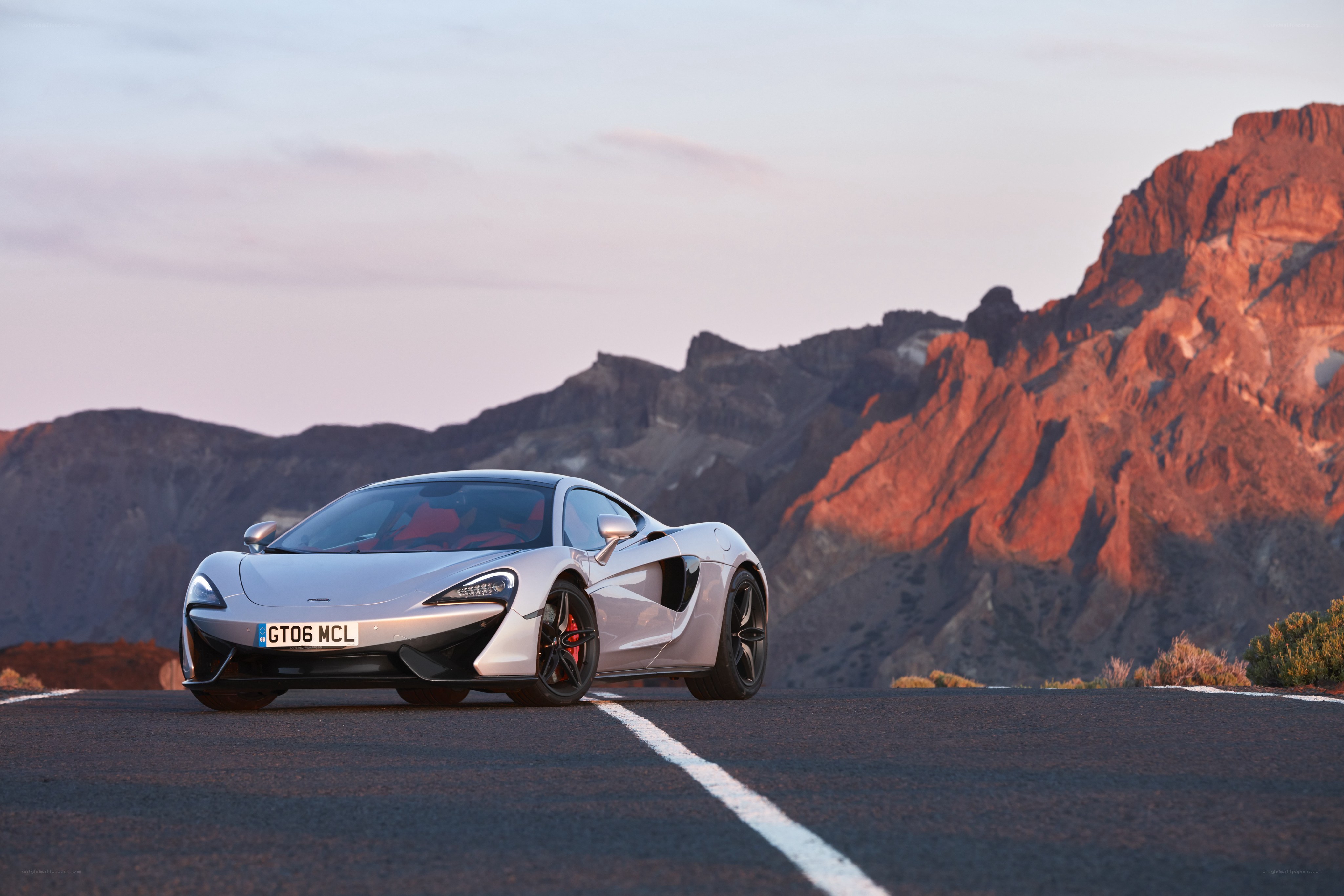 Silver McLaren on mountain road