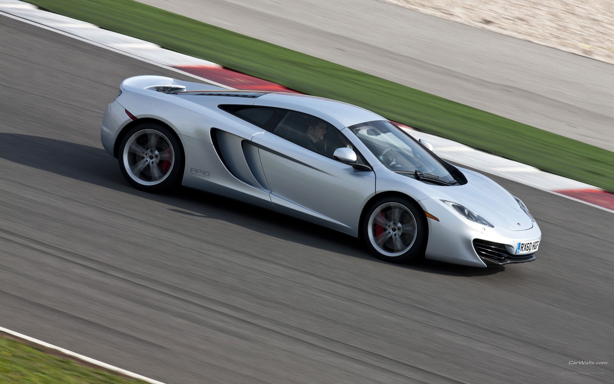 silver mclaren on racetrack