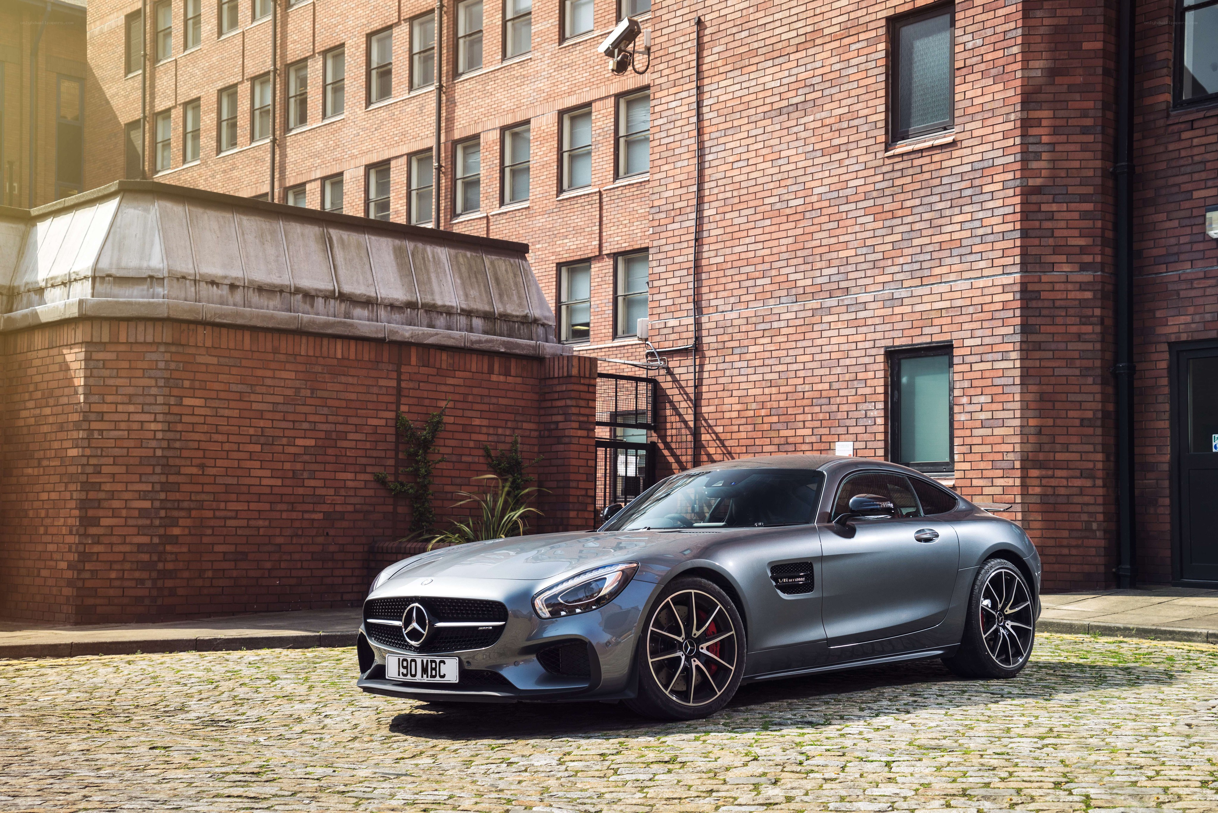 Silver Mercedes-AMG GT parked on cobblestones