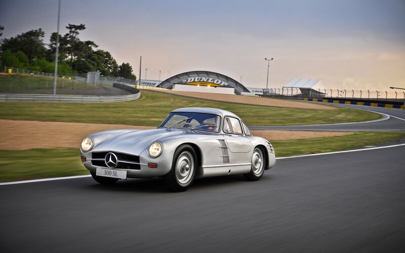 Silver Mercedes-Benz 300 SL on a racetrack