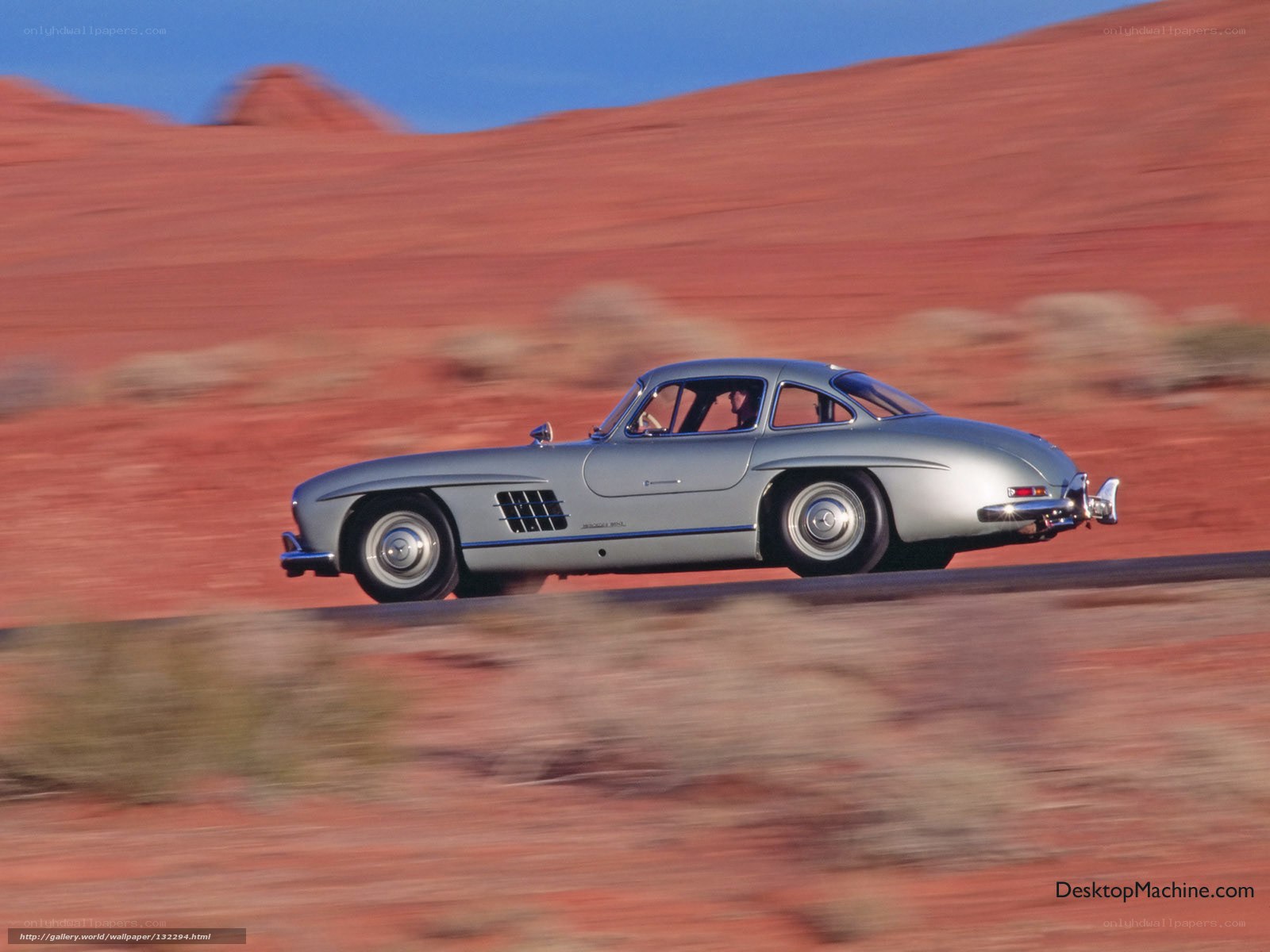Silver Mercedes-Benz 300SL driving