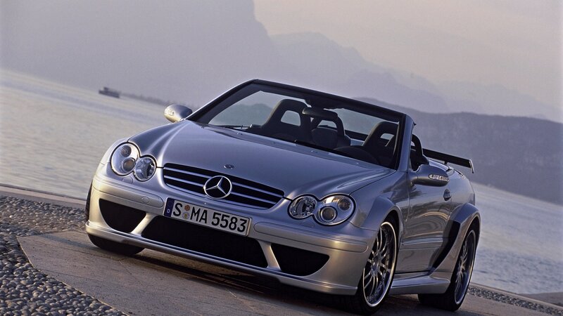 Silver Mercedes-Benz convertible by water