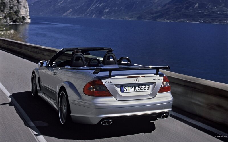 Silver Mercedes-Benz convertible on a lakeside road