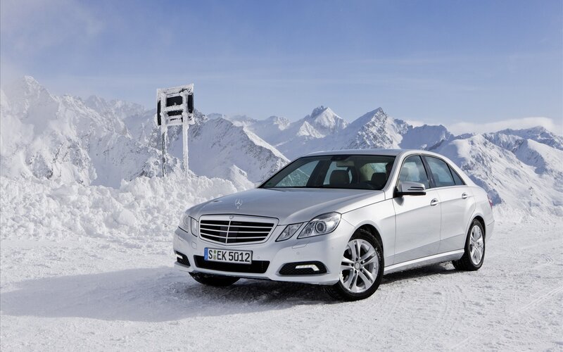 Silver Mercedes-Benz in snowy mountains