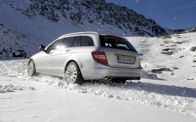 Silver Mercedes-Benz in snowy mountains