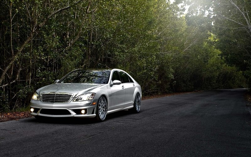 Silver Mercedes-Benz on a forest road